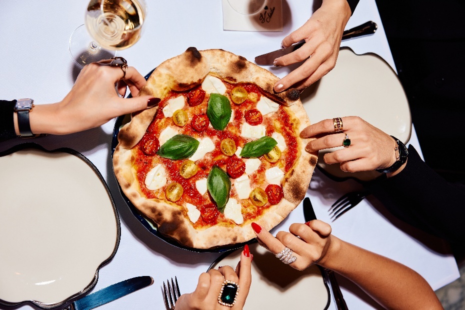 A group of people at a table with a pizzaAI-generated content may be incorrect. A group of people at a table with a pizzaAI-generated content may be incorrect.