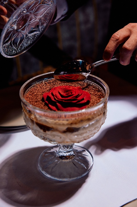 A person pouring a spoon into a dessertAI-generated content may be incorrect.